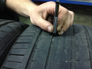 Using a Tread Depth Indicator on a worn out tire